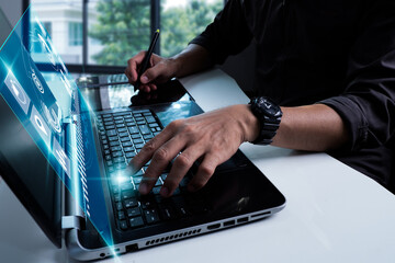A man programmer uses a laptop to analyze and develop diverse data on a future virtual interface screen. Artificial intelligence algorithms, marketing, and deep learning