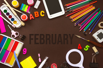 February. Month, Calendar month. School notebook and various stationery with calendar day. School and office supplies frame. Winter , month of the year concept.