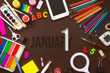 January 1st . Day 1 of month, Calendar date. School notebook and various stationery with calendar day. School and office supplies frame. Winter month, day of the year concept.