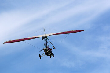 Fototapeta na wymiar Ultralight airplane flying in a blue sky 