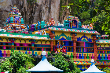 Fragment of colorful Hindu Temple decorated with rainbow statues of hindu gods near Batu caves in...
