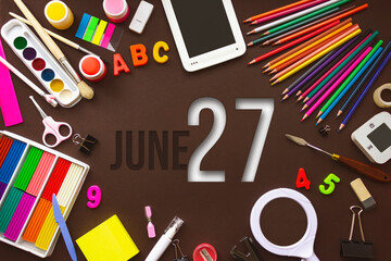 June 27th. Day 27 of month, Calendar date. School notebook and various stationery with calendar day. School and office supplies frame. Summer month, day of the year concept.