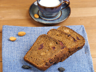 Rye bread on a blue napkin. A cup of milk. Selective focus.