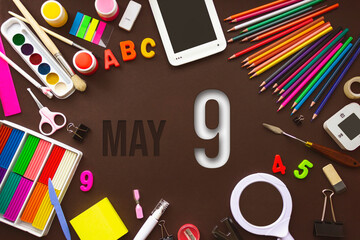 May 9th. Day 9 of month, Calendar date. School notebook and various stationery with calendar day. School and office supplies frame. Spring month, day of the year concept.