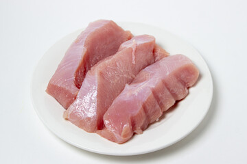 Raw turkey steaks on a white plate. Turkey breast fillet on a plate. Diet meat