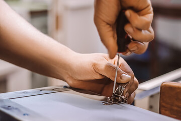 Furniture assembler mechanic works with screwdriver. Male worker installs metal latch. Hands hold repair tool. Small business support.