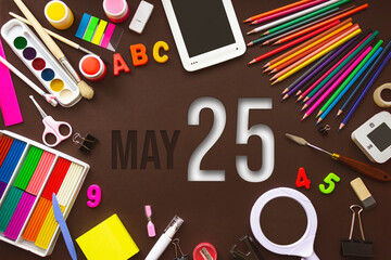 May 25th. Day 25 of month, Calendar date. School notebook and various stationery with calendar day. School and office supplies frame. Spring month, day of the year concept.