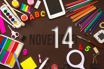 November 14th. Day 14 of month, Calendar date. School notebook and various stationery with calendar day. School and office supplies frame. Autumn month, day of the year concept.