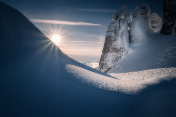 Beautiful sunset scene in the mountains during winter with some rocks resembling a kiss between two lovers