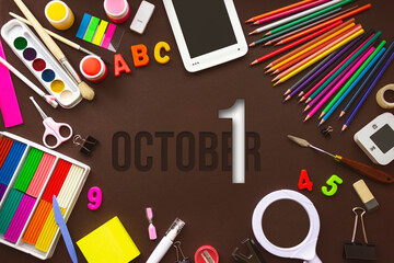 October 1st . Day 1 of month, Calendar date. School notebook and various stationery with calendar day. School and office supplies frame. Autumn month, day of the year concept.