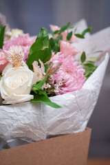 Bouquet of white roses and pink chrysanthemums in a package close-up