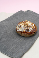 Brownie with nuts on a gray napkin in the kitchen