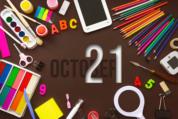 October 21st . Day 21 of month, Calendar date. School notebook and various stationery with calendar day. School and office supplies frame. Autumn month, day of the year concept.