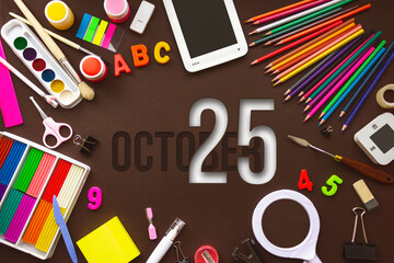 October 25th. Day 25 of month, Calendar date. School notebook and various stationery with calendar day. School and office supplies frame. Autumn month, day of the year concept.