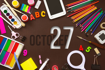 October 27th. Day 27 of month, Calendar date. School notebook and various stationery with calendar day. School and office supplies frame. Autumn month, day of the year concept.