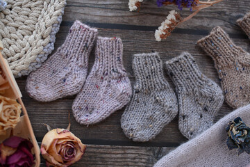 Fototapeta na wymiar Warm and soft tiny newborn socks made of woolen yarn