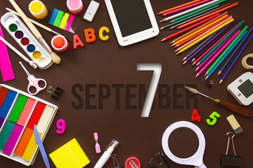 September 7th. Day 7 of month, Calendar date. School notebook and various stationery with calendar day. School and office supplies frame. Autumn month, day of the year concept.