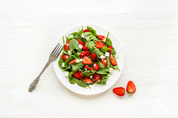 Vegetarian diet - green spinach salad with strawberry and goat cheese