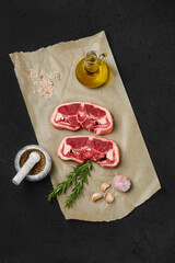 Top view of raw lamb double loin chop on wrapping paper
