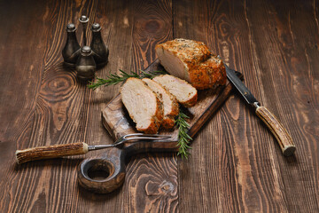 Pork collar joint baked in oven on wooden serving board