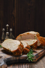 Closeup view of pork collar joint baked in oven on wooden serving board