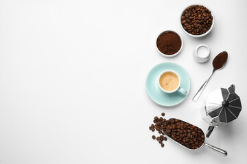 Flat lay composition with coffee grounds and roasted beans on white background, space for text
