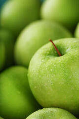Juicy Green apple close-up with dew drops.