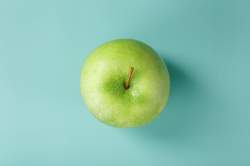Juicy Green apple on a green background with a minimalistic composition.