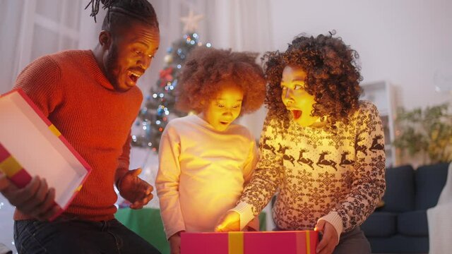 Amazed Black Family Opening Gift Box, Christmas Surprise, Holidays Are Coming