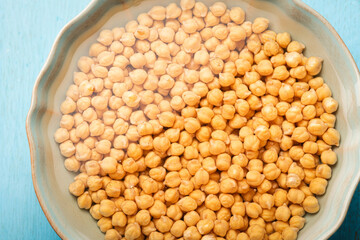 A bowl of dried chickpeas soaked in water