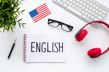 Learning English language concept. Text on student table desk, top view