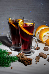 Mulled wine in a glass glass on a gray concrete background
