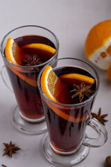 Mulled wine in a glass glass on a gray concrete background