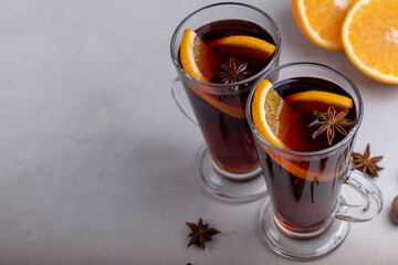 Mulled wine in a glass glass on a gray concrete background