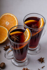 Mulled wine in a glass glass on a gray concrete background