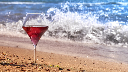 Wine glass with a cocktail by the sea.