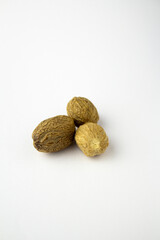 Dried nutmeg isolated on a white background