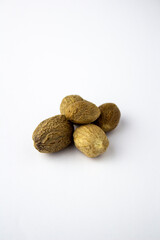 Dried nutmeg isolated on a white background