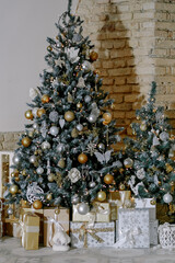 Christmas, New Year interior with red brick wall background, decorated fir tree with garlands and balls. Holiday decorated room with chair