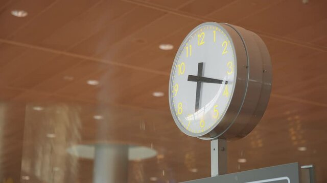Close up view of a white clock at the airport terminal. 