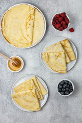 Traditional Russian pancakes with berries and honey. Russian breakfast with pancakes. Pancake week concept, Maslenitsa