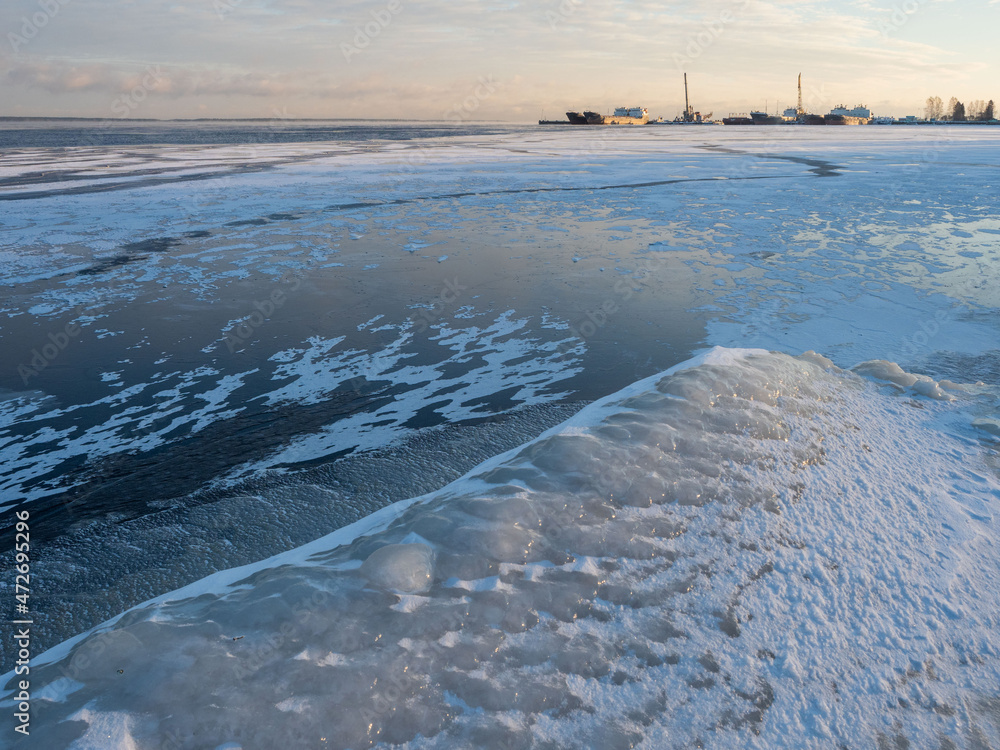 Wall mural View of the embankment covered with snow and ice after a winter storm in Petrozavodsk in the Republic of Karelia on a clear frosty day in December