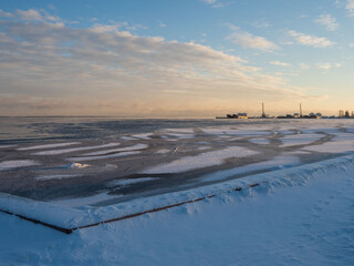 View of the embankment covered with snow and ice after a winter storm in Petrozavodsk in the Republic of Karelia on a clear frosty day in December