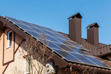 Solar panels on house roof. Alternative energy sources. Sunlight.