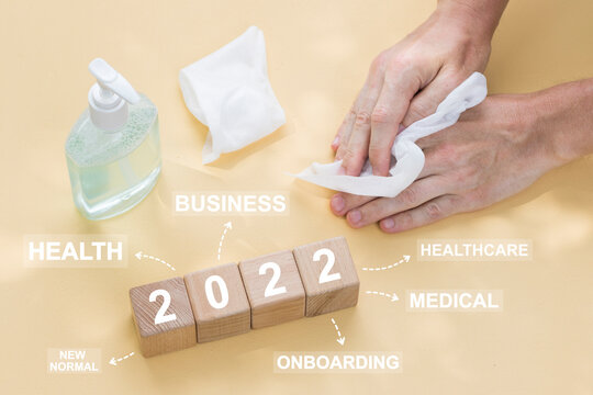Doctor hand arranging wood block stacking with healthcare 2022 year concept, insurance for your health.