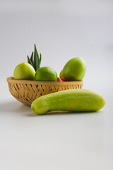 Raw vegetable in wooden bowl on white background.
