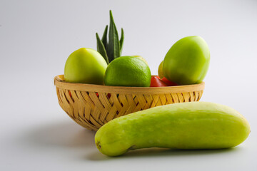 Raw vegetable in wooden bowl on white background.