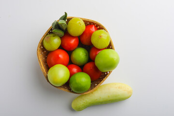 Raw vegetable in wooden bowl on white background.