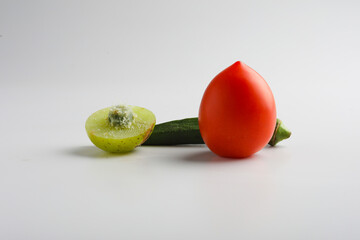 ladyfinger red tomato and indian gooseberry on white background.