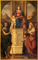 FERRARA, ITALY - NOVEMBER 9, 2021: The painting of Madonna with St. John the Baptist, Jerome and other in church Chiesa di San Francesco by Giovanni Fei (1864) as the copy of Garofalo (1523).